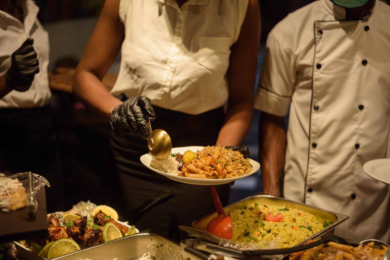 services-02 Catering service in Enugu, Nigeria with delicious buffet offerings served by staff.
